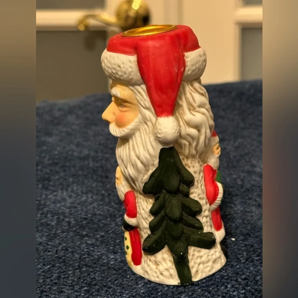 Set of 2 Santa candleholders. Each has smaller different smaller Santas.